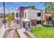 Striking modern home with a manicured lawn and walkway leading to the covered front porch at 1491 S York St, Denver, CO 80210