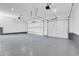 Spacious three car garage featuring newly epoxied floors and automatic door openers at 1491 S York St, Denver, CO 80210