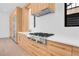 Well-equipped kitchen featuring stainless steel appliances, wood cabinets, and a modern range hood at 1491 S York St, Denver, CO 80210