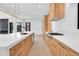Bright kitchen with light wood cabinetry, long countertops, and stainless steel appliances, perfect for cooking at 1491 S York St, Denver, CO 80210
