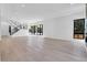 Bright and open living room featuring hardwood floors, modern staircase, and large windows, offering abundant natural light at 1491 S York St, Denver, CO 80210