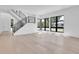Bright and open living room featuring hardwood floors, modern staircase, and large windows offering natural light at 1491 S York St, Denver, CO 80210