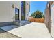 Contemporary patio with concrete pad and black metal railings leading to the front door at 1491 S York St, Denver, CO 80210