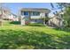 Spacious backyard featuring a lush lawn and a charming two-story home at 20550 E Lake Cir, Centennial, CO 80016