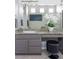 Bathroom vanity with granite countertops, gray cabinetry, and elegant decor at 20550 E Lake Cir, Centennial, CO 80016