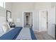 A well-lit bedroom featuring a large window, carpet, and access to the walk in closet at 20550 E Lake Cir, Centennial, CO 80016