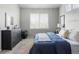 A relaxing bedroom with a large window, plush carpet, and a stylish dresser at 20550 E Lake Cir, Centennial, CO 80016
