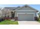Charming single Gathering home featuring a gray two-car garage and manicured lawn at 20550 E Lake Cir, Centennial, CO 80016
