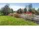Community playground area with lush grass, trees, and a white picket fence at 20550 E Lake Cir, Centennial, CO 80016