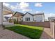 Backyard with lush green grass, privacy fence, and covered patio for a serene outdoor space at 1426 Swan Peter Dr, Berthoud, CO 80513