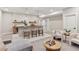 Finished basement bar features a stone backsplash, pendant lights, and comfortable seating area at 1426 Swan Peter Dr, Berthoud, CO 80513