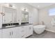 Luxurious primary bathroom featuring dual sinks, a soaking tub, and modern fixtures at 1426 Swan Peter Dr, Berthoud, CO 80513