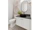 Stylish powder room featuring a black vessel sink, oval mirror and patterned tile flooring at 1426 Swan Peter Dr, Berthoud, CO 80513