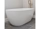 Freestanding soaking tub with modern faucet and stylish tile flooring at 1426 Swan Peter Dr, Berthoud, CO 80513