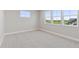Spacious bedroom with soft carpeting and large windows providing beautiful natural light and an expansive view at 1426 Swan Peter Dr, Berthoud, CO 80513
