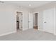 Spacious bedroom featuring plush carpeting, two entry doors, and neutral wall paint at 1426 Swan Peter Dr, Berthoud, CO 80513