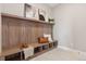 Cozy entryway featuring a built-in bench with storage, adorned with decorative pillows and stylish artwork at 1426 Swan Peter Dr, Berthoud, CO 80513
