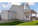 Rear view of a two-story home showcasing light gray siding and a covered patio for outdoor enjoyment at 1426 Swan Peter Dr, Berthoud, CO 80513