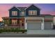 Charming home with a two-car garage and inviting front porch, featuring a wreath on the front door at 1426 Swan Peter Dr, Berthoud, CO 80513