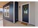 Inviting front entryway featuring a stylish blue door adorned with a green wreath, complemented by wood accents at 1426 Swan Peter Dr, Berthoud, CO 80513