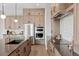 Spacious kitchen featuring stainless steel appliances, sleek countertops, and modern lighting fixtures at 1426 Swan Peter Dr, Berthoud, CO 80513