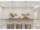 Modern basement kitchenette with a breakfast bar, decorative backsplash, floating shelves, and sleek pendant lights at 1426 Swan Peter Dr, Berthoud, CO 80513