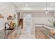 Basement kitchenette featuring dark countertops, modern fixtures, backsplash, decor, and stairs to the main level at 1426 Swan Peter Dr, Berthoud, CO 80513