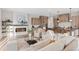 Inviting open-concept living space with a modern kitchen and cozy seating near fireplace at 1426 Swan Peter Dr, Berthoud, CO 80513