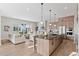 Open-concept living space featuring a modern kitchen island, cozy living room, and elegant decor at 1426 Swan Peter Dr, Berthoud, CO 80513