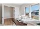 Well-lit office space with a modern desk and a view of the neighborhood through large windows at 1426 Swan Peter Dr, Berthoud, CO 80513