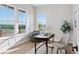 Well-lit office with hardwood floors, modern desk, and large windows with scenic views at 1426 Swan Peter Dr, Berthoud, CO 80513