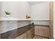 Convenient pantry with light wood cabinetry, dark countertops, mosaic backsplash, and ample shelving at 1426 Swan Peter Dr, Berthoud, CO 80513