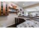 Well-appointed basement bar with granite countertops and a wine cooler at 24237 E Glasgow Cir, Aurora, CO 80016