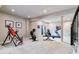 Home gym featuring various exercise equipment, including a treadmill and stationary bike at 24237 E Glasgow Cir, Aurora, CO 80016