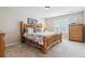 Spacious bedroom with a wooden bed frame and dresser at 24237 E Glasgow Cir, Aurora, CO 80016