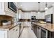 Large kitchen with granite countertops, island, and stainless steel appliances at 24237 E Glasgow Cir, Aurora, CO 80016