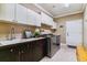 Bright laundry room with ample cabinetry, sink, and newer washer/dryer at 24237 E Glasgow Cir, Aurora, CO 80016