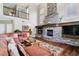 Two-story living room with a stone fireplace and hardwood floors at 24237 E Glasgow Cir, Aurora, CO 80016