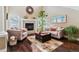 Living room with hardwood floors, fireplace and comfortable seating at 24237 E Glasgow Cir, Aurora, CO 80016