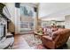 Two-story living room with a stone fireplace and large windows at 24237 E Glasgow Cir, Aurora, CO 80016