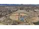 The aerial view showcases baseball fields and recreational areas adjacent to the neighborhood and its convenient parking at 9395 W Kentucky Ave, Lakewood, CO 80226