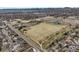 Expansive aerial view of the large park area featuring green spaces, walking paths, and ponds with a mountain backdrop at 9395 W Kentucky Ave, Lakewood, CO 80226