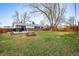 Expansive backyard with grass, mature trees, and a fenced-in perimeter offering privacy at 9395 W Kentucky Ave, Lakewood, CO 80226