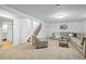 Basement living area with a couch, printed accent chair, and staircase at 9395 W Kentucky Ave, Lakewood, CO 80226