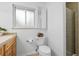 Bright bathroom with a toilet, glass-enclosed shower, and tiled countertop at 9395 W Kentucky Ave, Lakewood, CO 80226