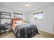 Bedroom with a comfy queen-size bed, natural light, and stylish furniture at 9395 W Kentucky Ave, Lakewood, CO 80226