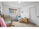 Comfortable bedroom with natural light, crib, and seating area at 9395 W Kentucky Ave, Lakewood, CO 80226