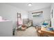 Well-lit bedroom with natural light, crib, and playful décor at 9395 W Kentucky Ave, Lakewood, CO 80226