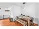 Bright dining area with a wooden table, bench seating, and modern lighting at 9395 W Kentucky Ave, Lakewood, CO 80226