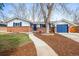 Charming brick home with blue accents, a mature tree, and inviting curb appeal at 9395 W Kentucky Ave, Lakewood, CO 80226